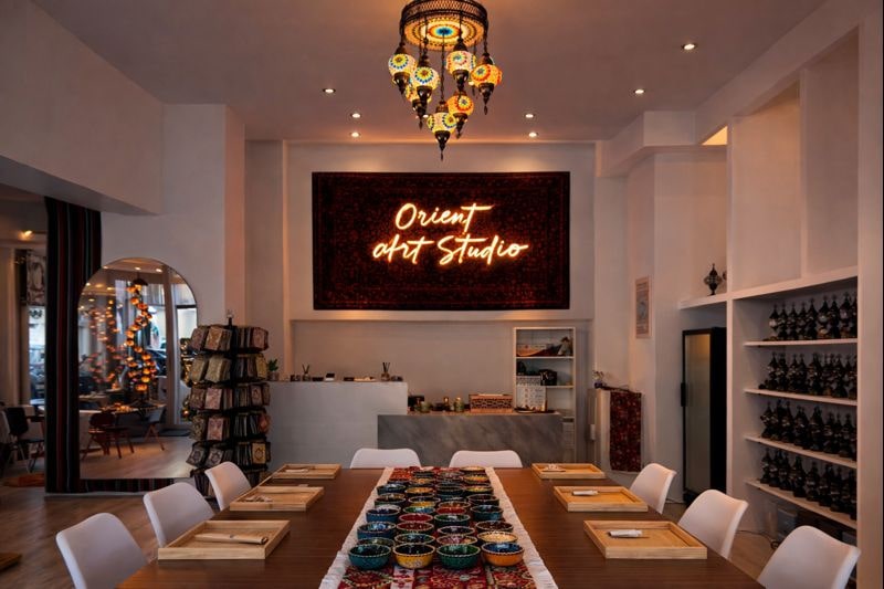 Interior of Orient Art Studio in Berlin with a large workshop table and oriental mosaic lamps