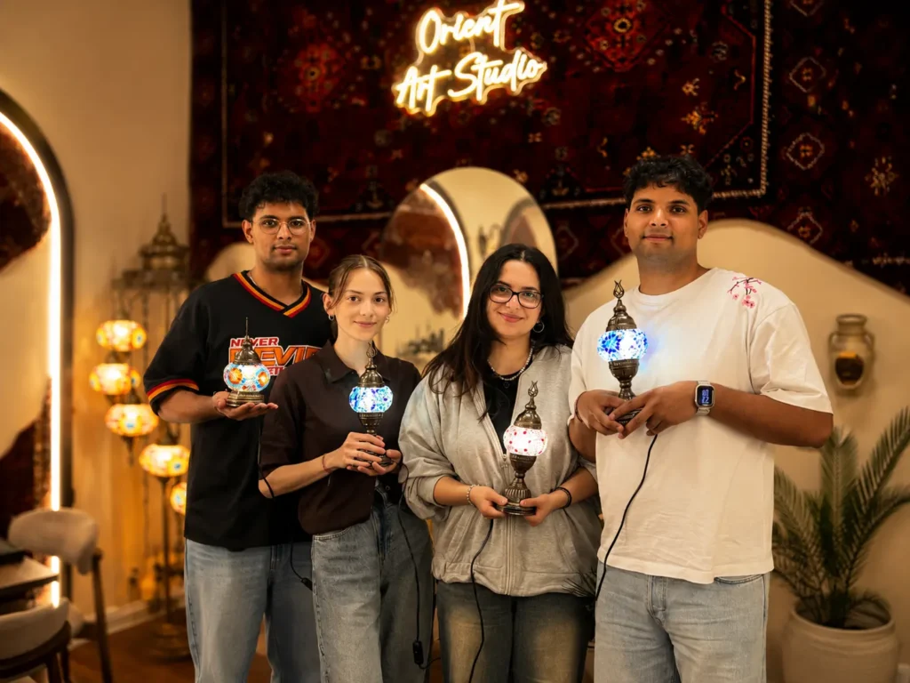 Group of participants with self-designed glowing mosaic lamps at Orient Art Studio Berlin